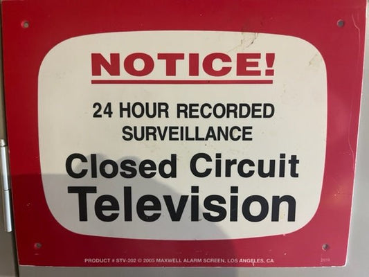 Technician servicing an IP/PoE security camera for managed video surveillance in Austin, Texas