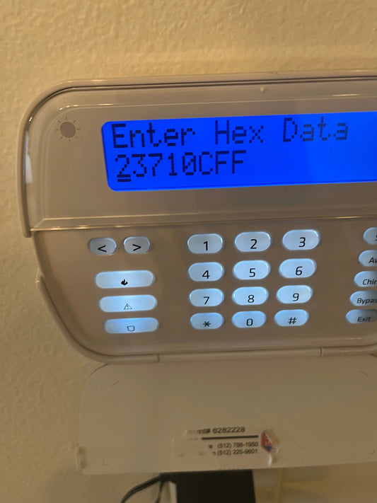 Avenger Security technician installing an access control reader at an Austin business—24/7 monitoring with video verification.